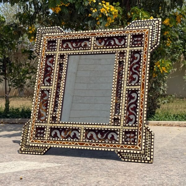 Handmade wooden mirror frame with intricate mother-of-pearl inlay in an Arabesque design.